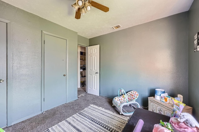 bedroom featuring carpet flooring, visible vents, and a ceiling fan