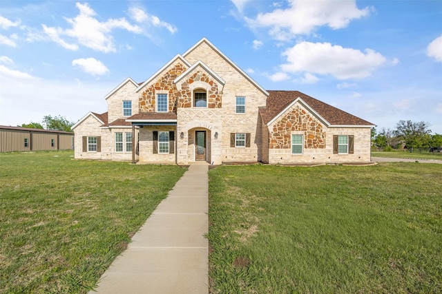 view of front of house with a front yard and stone siding