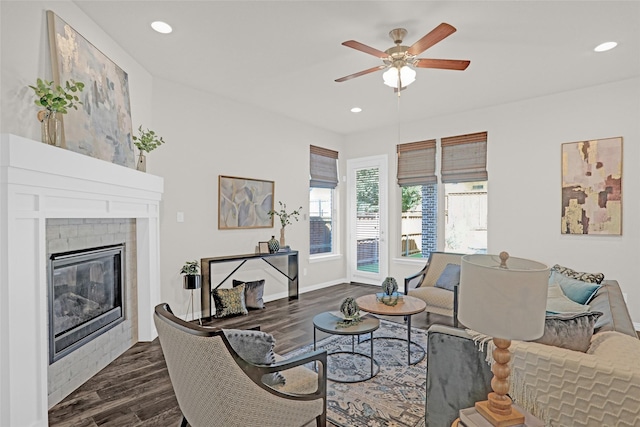 3341 Man O War Rd, Celina, TX 75009 - living area with dark wood-style flooring, a ceiling fan, recessed lighting, a glass covered fireplace, and baseboards