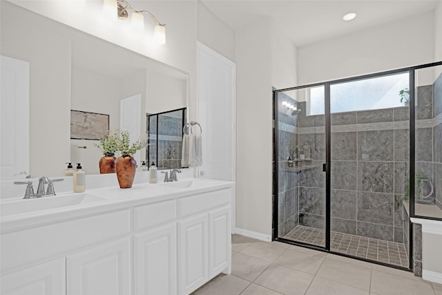 3341 Man O War Rd, Celina, TX 75009 - full bathroom featuring a stall shower, double vanity, tile patterned floors, and baseboards