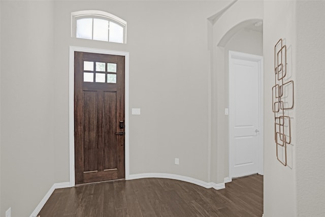 3341 Man O War Rd, Celina, TX 75009 - foyer entrance with dark wood-style floors, arched walkways, and baseboards