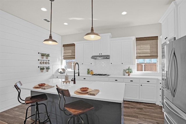 3341 Man O War Rd, Celina, TX 75009 - kitchen featuring freestanding refrigerator, under cabinet range hood, gas cooktop, decorative backsplash, and light countertops