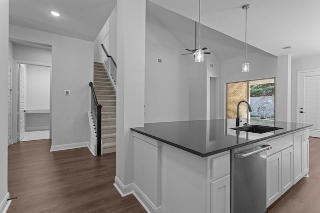 kitchen featuring white cabinetry, visible vents, a sink, dark countertops, and baseboards