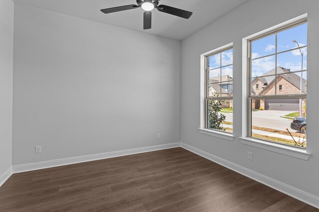unfurnished room featuring dark wood-style flooring, baseboards, and a ceiling fan