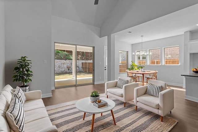 living room featuring wood finished floors, baseboards, and plenty of natural light