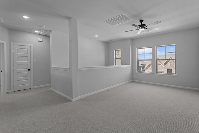 spare room featuring visible vents, baseboards, a ceiling fan, and carpet