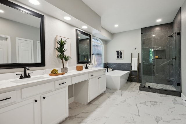 full bath with recessed lighting, a marble finish shower, and a sink