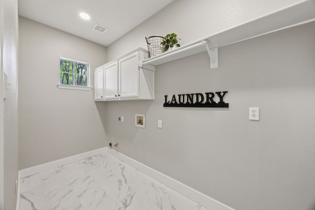 clothes washing area featuring hookup for a gas dryer, baseboards, electric dryer hookup, cabinet space, and washer hookup