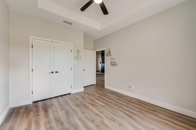 unfurnished bedroom featuring visible vents, baseboards, and light wood finished floors