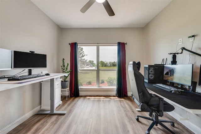 office space with light wood-style floors, baseboards, and a ceiling fan