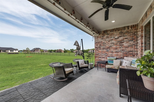 view of patio featuring ceiling fan, fence, and an outdoor hangout area