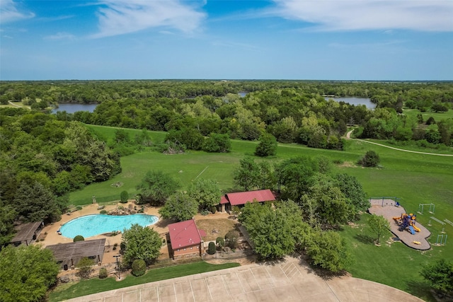 drone / aerial view featuring a water view and a view of trees