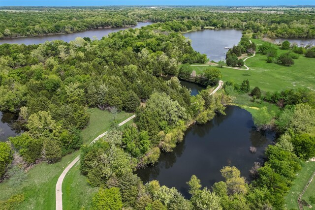 drone / aerial view featuring a water view and a view of trees