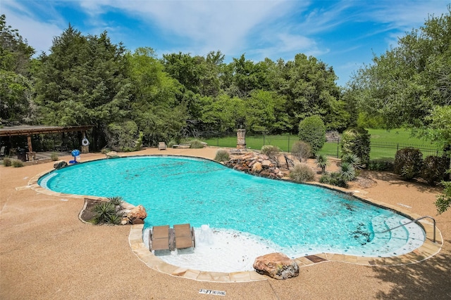 community pool featuring a patio and fence