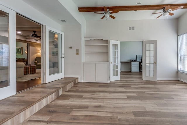interior space with wood finished floors, visible vents, french doors, and ceiling fan