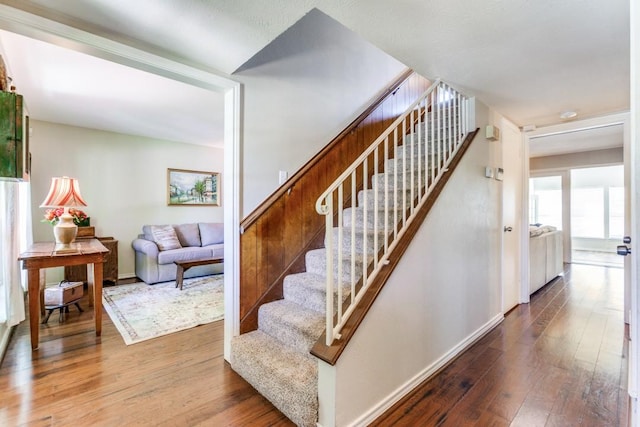 stairs featuring baseboards and wood-type flooring