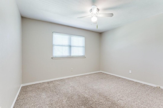 spare room featuring a ceiling fan, baseboards, and carpet