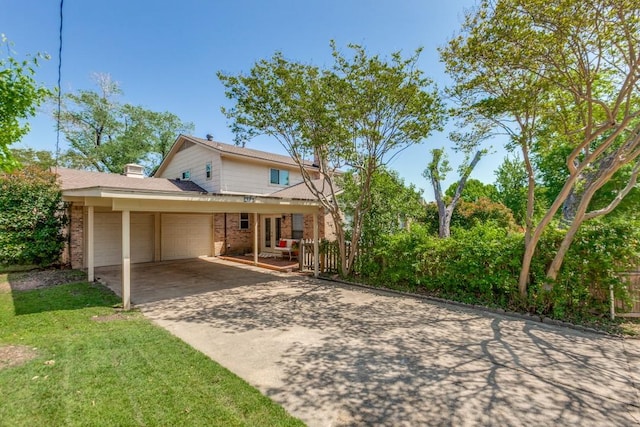 traditional-style home featuring driveway, french doors, brick siding, and a garage