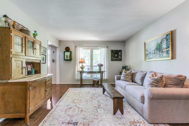 living room with dark wood-style flooring and baseboards