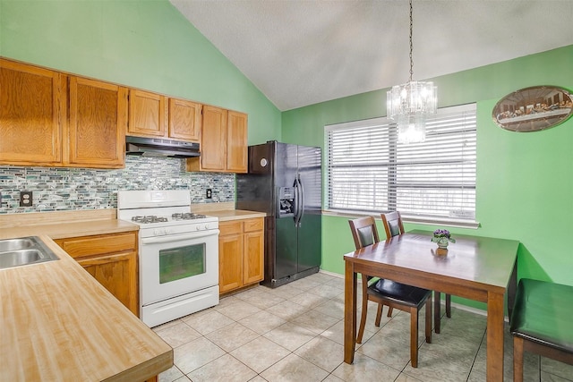 10125 Leatherwood Dr, Fort Worth, TX 76108 - kitchen featuring tasteful backsplash, light countertops, black fridge with ice dispenser, white range with gas stovetop, and under cabinet range hood