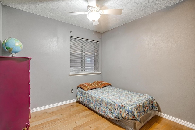 10125 Leatherwood Dr, Fort Worth, TX 76108 - bedroom with ceiling fan, baseboards, a textured ceiling, and wood finished floors