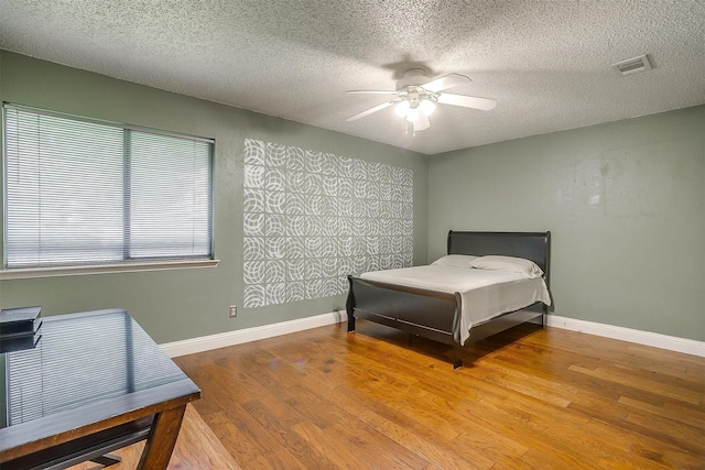 10125 Leatherwood Dr, Fort Worth, TX 76108 - bedroom featuring a textured ceiling, wood finished floors, and visible vents