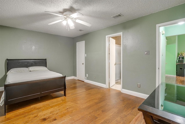 10125 Leatherwood Dr, Fort Worth, TX 76108 - bedroom featuring visible vents, baseboards, a textured ceiling, and wood finished floors