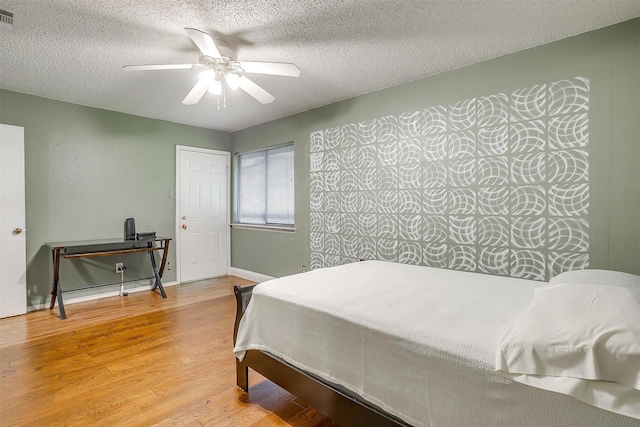 10125 Leatherwood Dr, Fort Worth, TX 76108 - bedroom with visible vents, baseboards, wood finished floors, and a textured ceiling