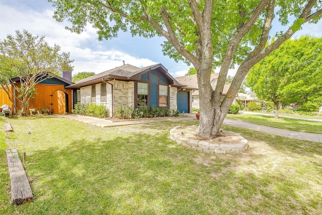10125 Leatherwood Dr, Fort Worth, TX 76108 - mid-century home with a front yard, an attached garage, stone siding, and an outbuilding