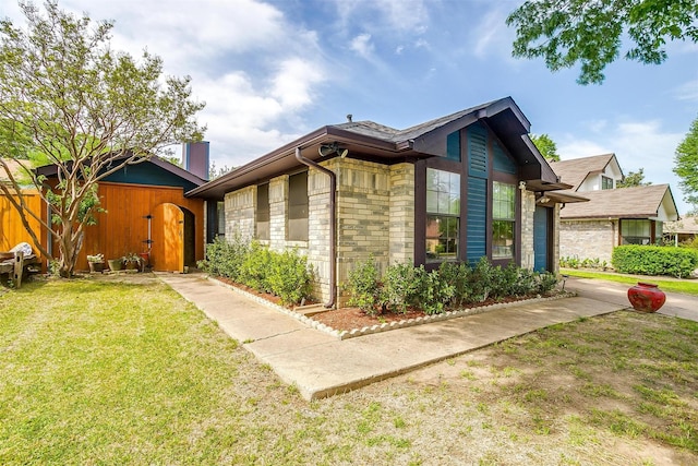 10125 Leatherwood Dr, Fort Worth, TX 76108 - view of front of property featuring a front yard, an outdoor structure, and stone siding