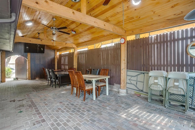10125 Leatherwood Dr, Fort Worth, TX 76108 - dining room with wooden walls, ceiling fan, brick floor, wood ceiling, and vaulted ceiling with beams