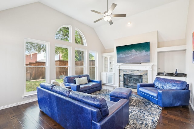 living area featuring ceiling fan, hardwood / wood-style flooring, and a healthy amount of sunlight