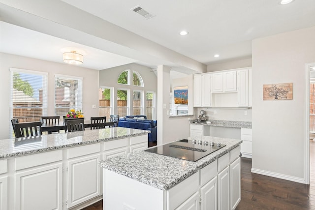 7812 Alderwood Pl, Plano, TX 75025 - kitchen featuring black electric stovetop, a center island, dark wood finished floors, recessed lighting, and baseboards
