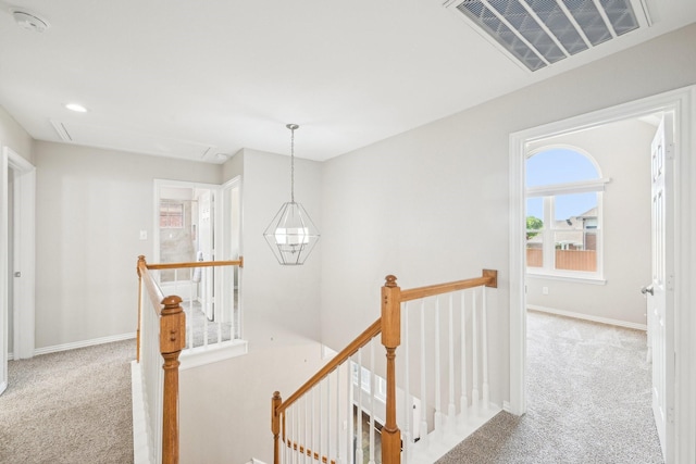 7812 Alderwood Pl, Plano, TX 75025 - hall featuring an upstairs landing, carpet, baseboards, a chandelier, and attic access