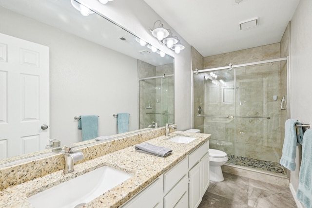 7812 Alderwood Pl, Plano, TX 75025 - full bathroom featuring a shower stall, double vanity, toilet, and marble finish floors