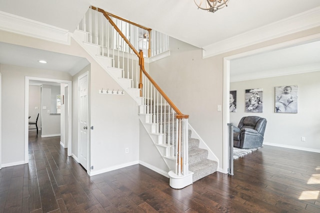 stairs featuring ornamental molding, hardwood / wood-style flooring, and baseboards
