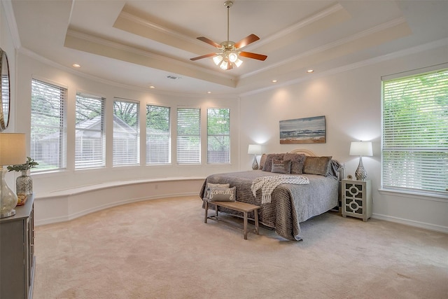 bedroom featuring ceiling fan, light carpet, a raised ceiling, ornamental molding, and visible vents