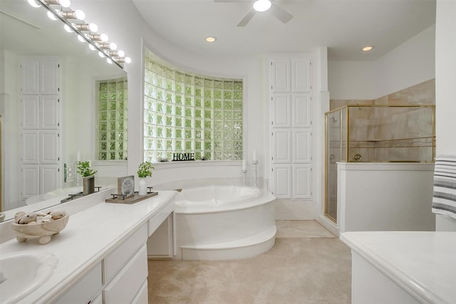 bathroom featuring a bath, a stall shower, recessed lighting, a ceiling fan, and vanity