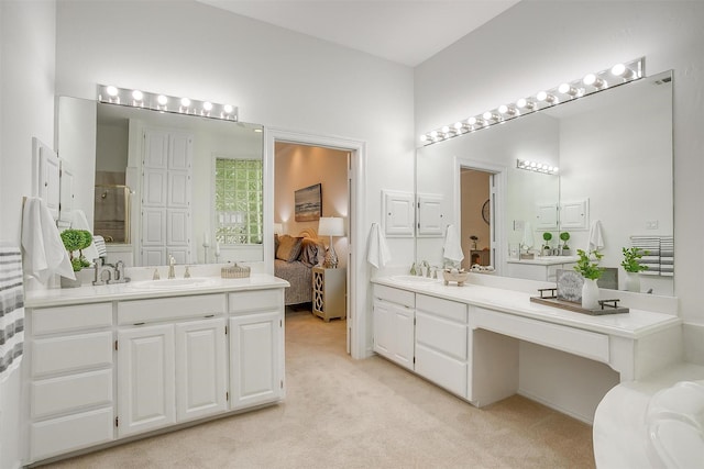 bathroom featuring two vanities, a stall shower, and a sink