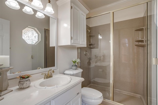 bathroom featuring a stall shower, vanity, ornamental molding, and toilet