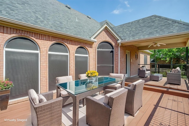 wooden terrace featuring ceiling fan, outdoor lounge area, and outdoor dining area