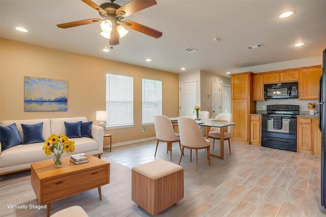 living area featuring ceiling fan, visible vents, and recessed lighting