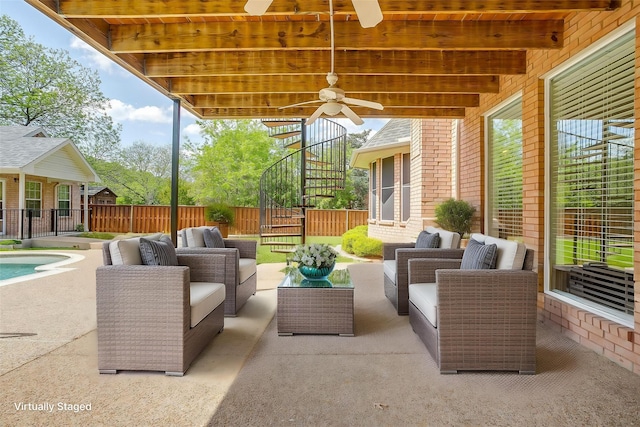 view of patio with fence, outdoor lounge area, a ceiling fan, and stairs