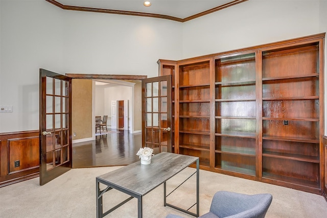 carpeted office space with crown molding and french doors