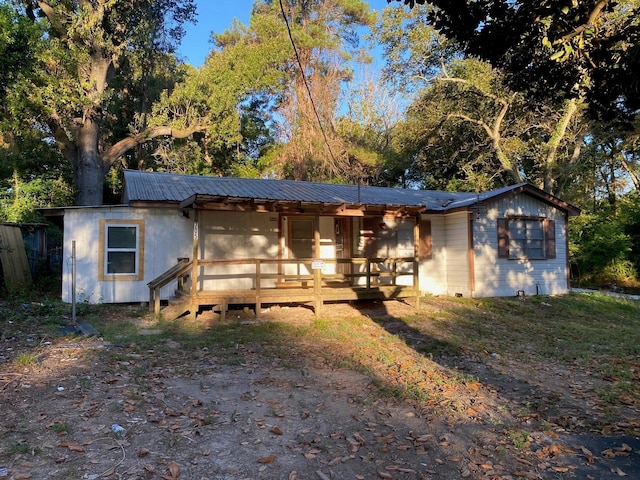 view of front of property with metal roof and crawl space