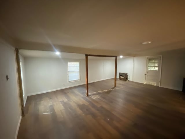 basement with baseboards and wood finished floors