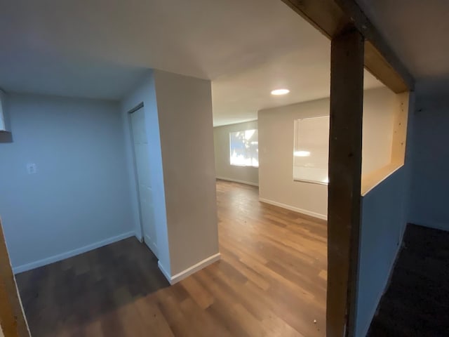 hallway with baseboards, recessed lighting, and wood finished floors