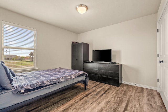bedroom featuring baseboards and light wood-type flooring