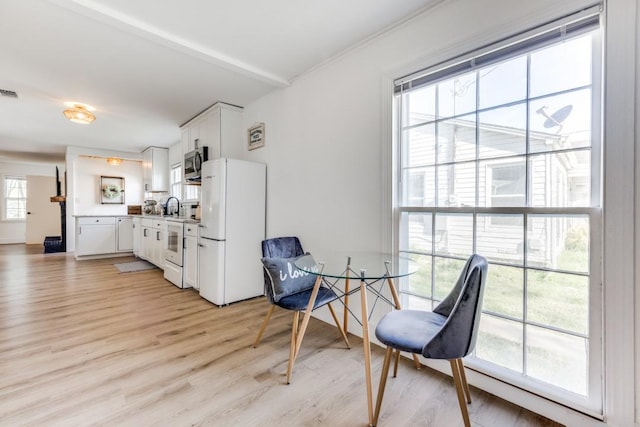dining room featuring visible vents and light wood finished floors