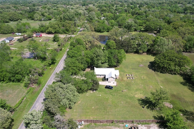 birds eye view of property with a forest view